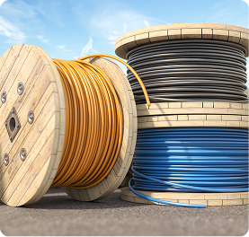 Building & Construction blurb | Polymer Additives Group Large Wooden Spools of Yellow, Blue, and Black Industrial Cabling Used in Building and Construction Applications.