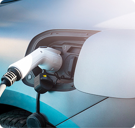Electric Vehicles | Polymer Additives Group Electric Vehicle Charging Port with a Plugged-in Connector, Illustrating Additive Applications for Ev Battery Safety.